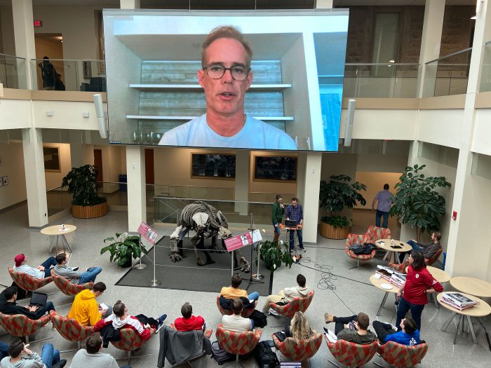 Joe Buck speaks to students through webcam in lobby of Media School