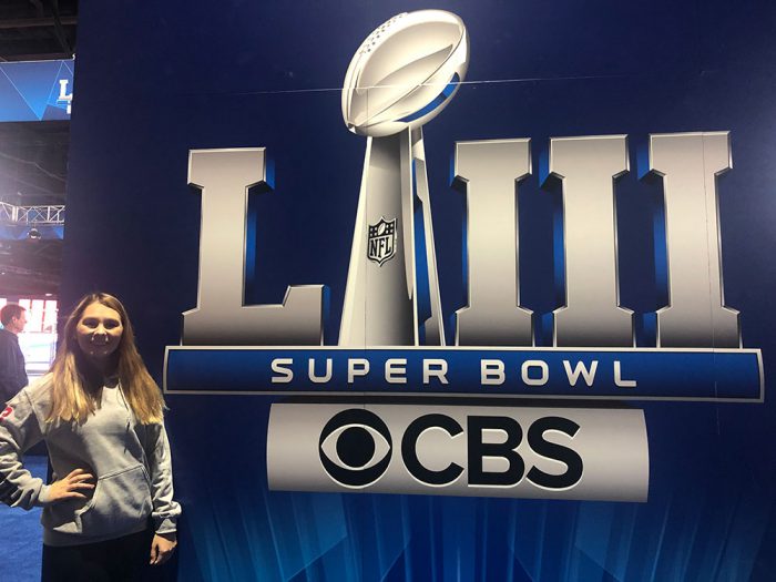 Morgan Gard posing with a CBS Super Bowl logo