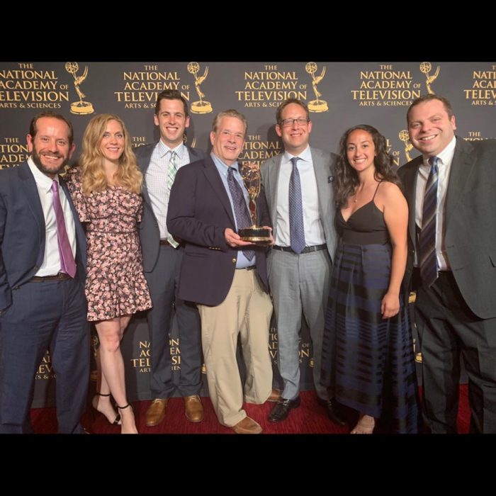 IU Media School graduate Adam Cohen and his NFL on CBS coverage team show off their Sports Emmy award on May 20 in New York City.